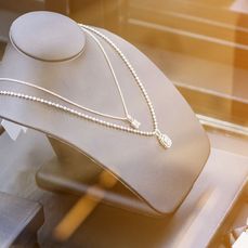 Diamond necklace inside glass jewelry display case